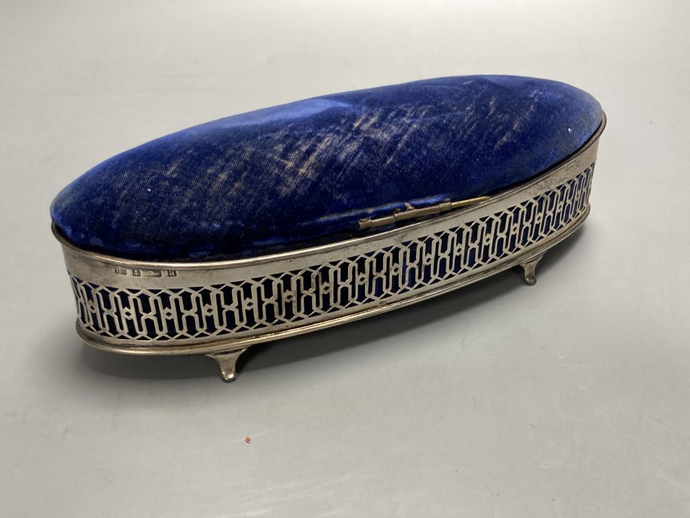 A navette-shaped silver trinket box with fretwork sides and hinged pin cushion top, Birmingham 1900, 20.3cm.